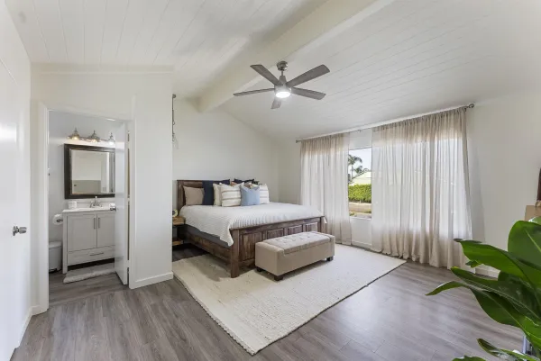 a spacious bedroom with a bed and a window