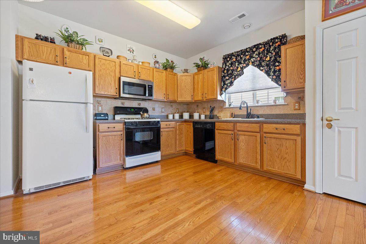 901 Nathaniel Trail Warminster, PA 18974 - Photo 7 of 30 a kitchen with stainless steel appliances granite countertop a refrigerator sink and stove
