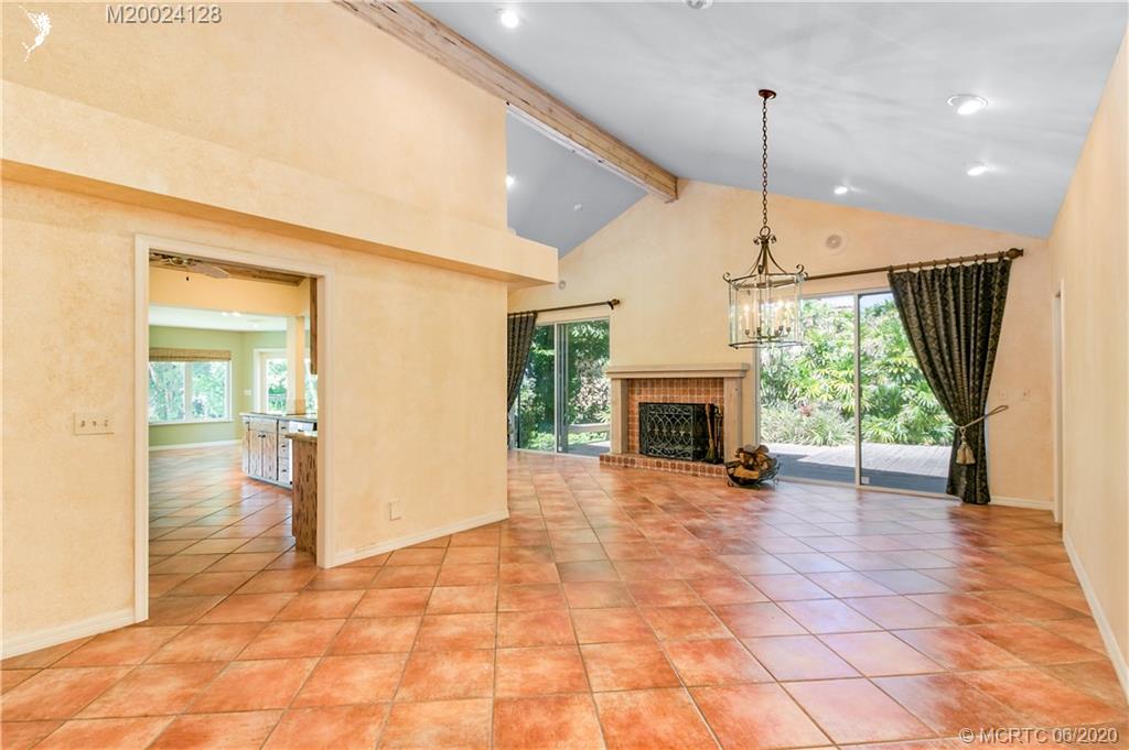 17 West High Point Road Stuart, FL 34996 - Photo 23 of 23 Open floor plan and wood burning fireplace. High cathedral ceilings.