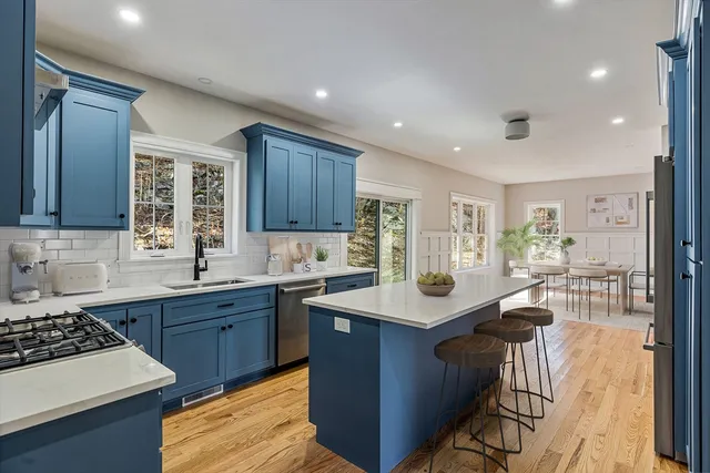 a kitchen with a sink stove and cabinets