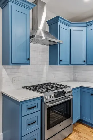 a kitchen with granite countertop a stove and a sink