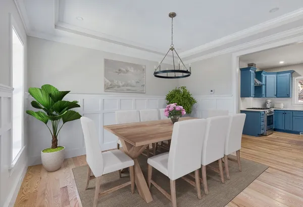 a view of a dining room with furniture wooden floor and chandelier