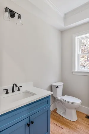 a white toilet sitting next to a bathroom sink