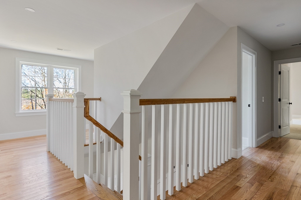 60 Wesson Street Grafton, MA 01536 - Photo 19 of 42 a view of a hallway with wooden floor and stairs