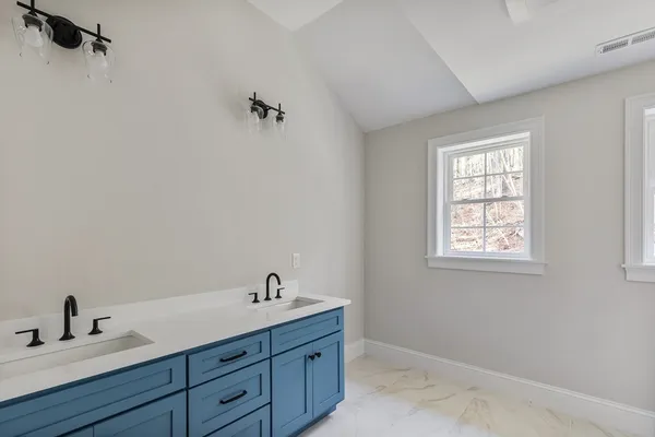 a bathroom with a sink and a window