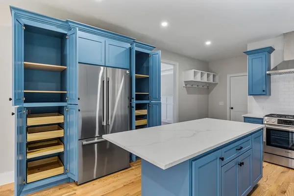 a kitchen with a refrigerator and a sink