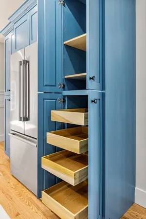 a kitchen with a refrigerator and cabinets