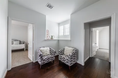 a living room with furniture and a lamp