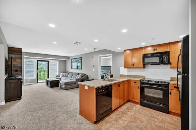 a kitchen that has a lot of cabinets in it and wooden floors