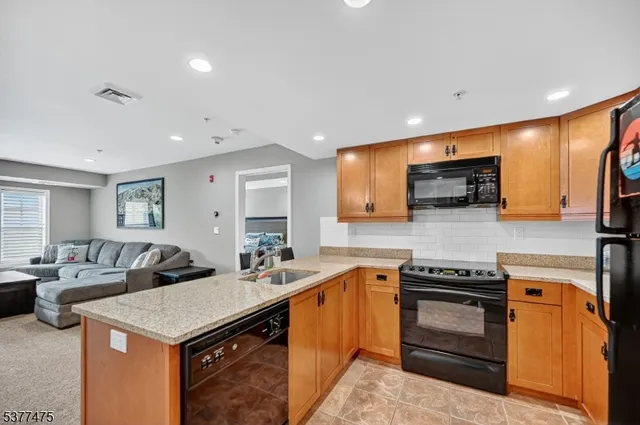 a bedroom with a bed and a refrigerator