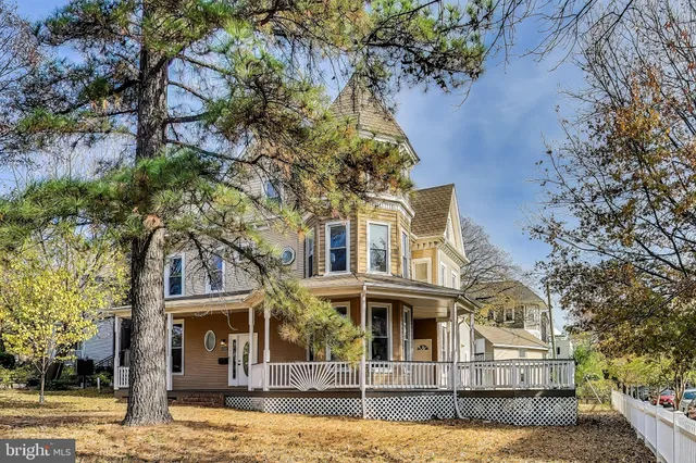 a view of a brick house with a wooden bench