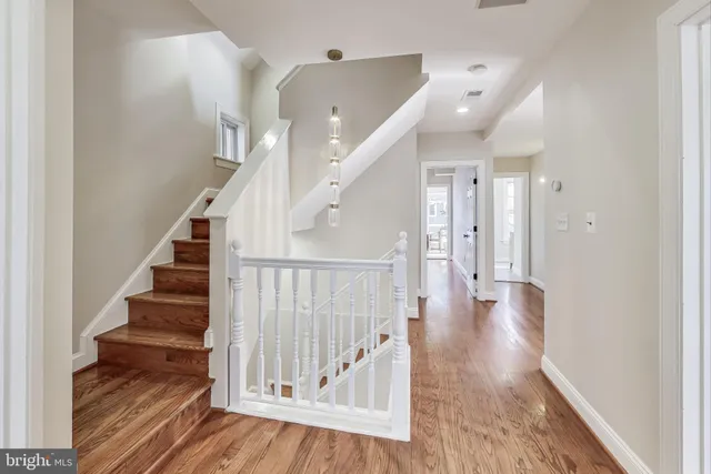 a view of a hallway with wooden floor