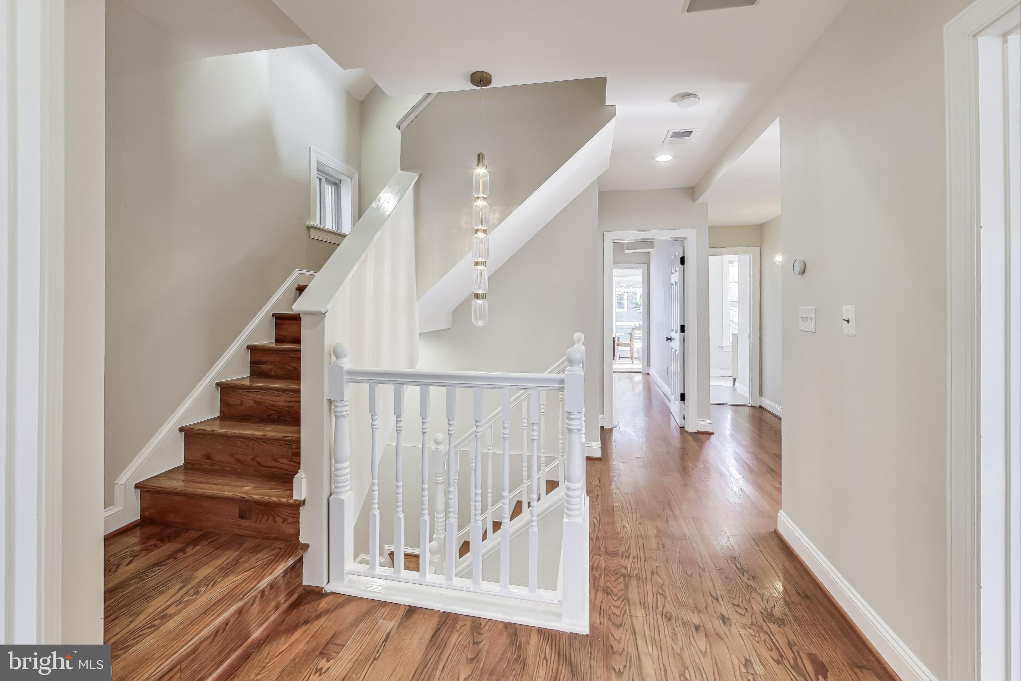 4301 Kansas Avenue Northwest Washington, DC 20011 - Photo 30 of 80 a view of staircase with wooden floor and white walls