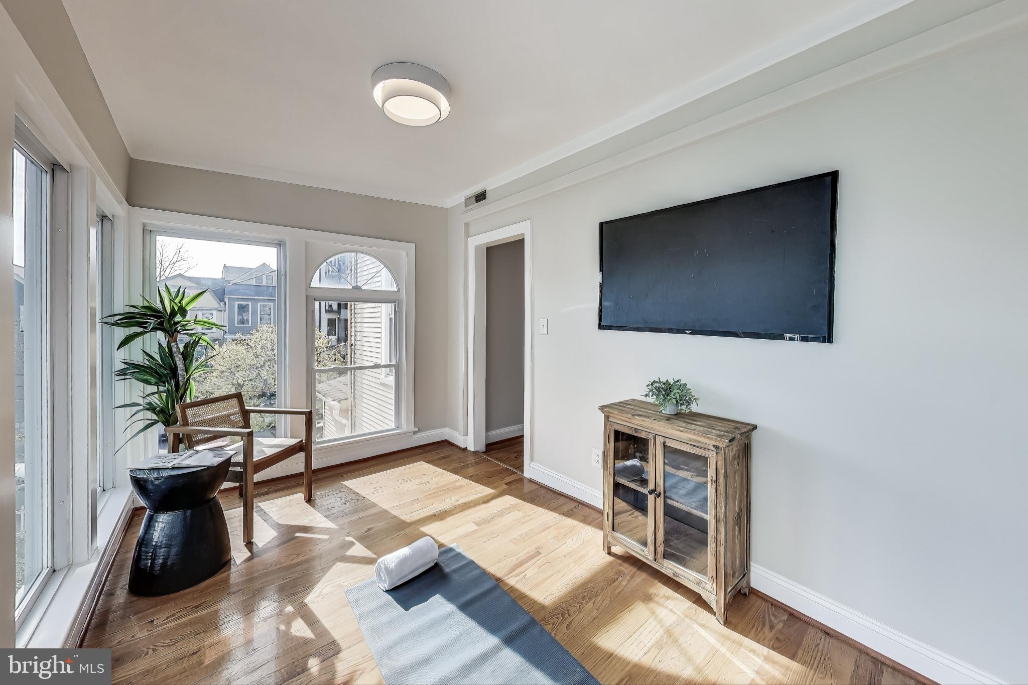 4301 Kansas Avenue Northwest Washington, DC 20011 - Photo 39 of 80 a living room with furniture and a flat screen tv