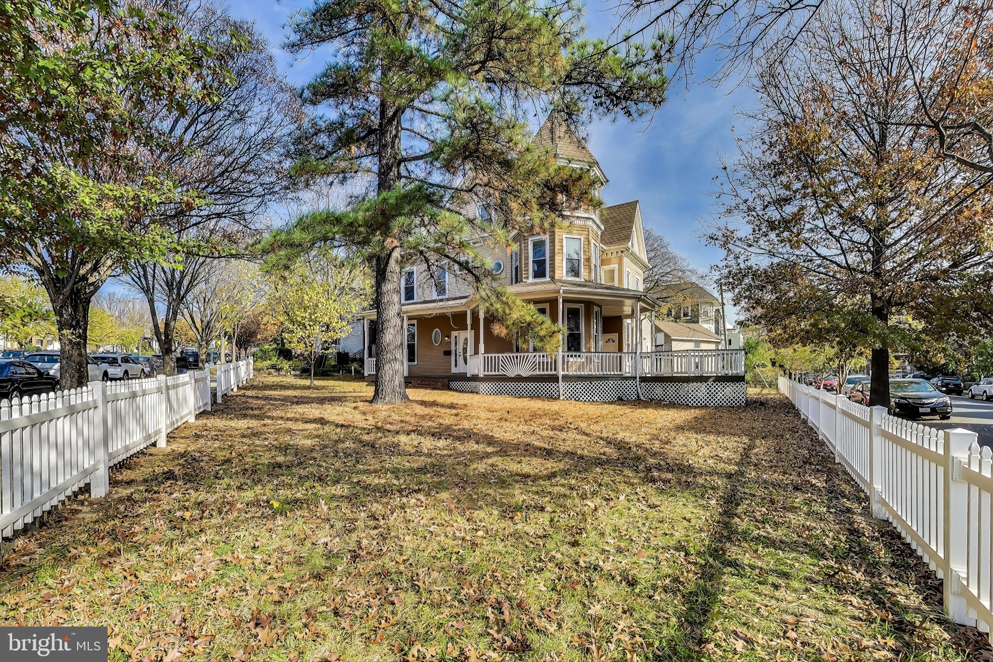 4301 Kansas Avenue Northwest Washington, DC 20011 - Photo 4 of 80 a view of a house with large trees and covered with wooden fence