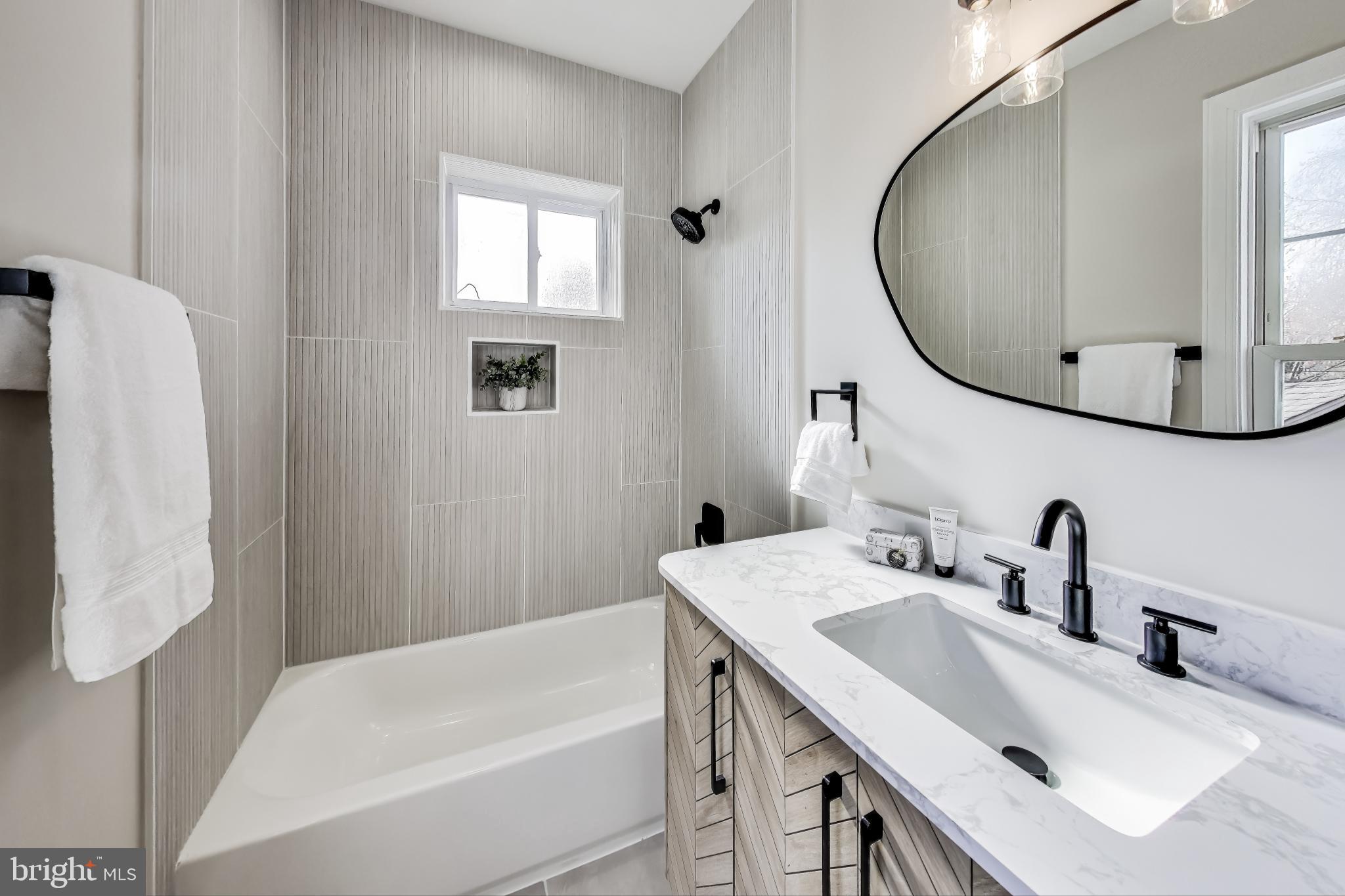 4301 Kansas Avenue Northwest Washington, DC 20011 - Photo 42 of 80 a bathroom with a tub sink and mirror