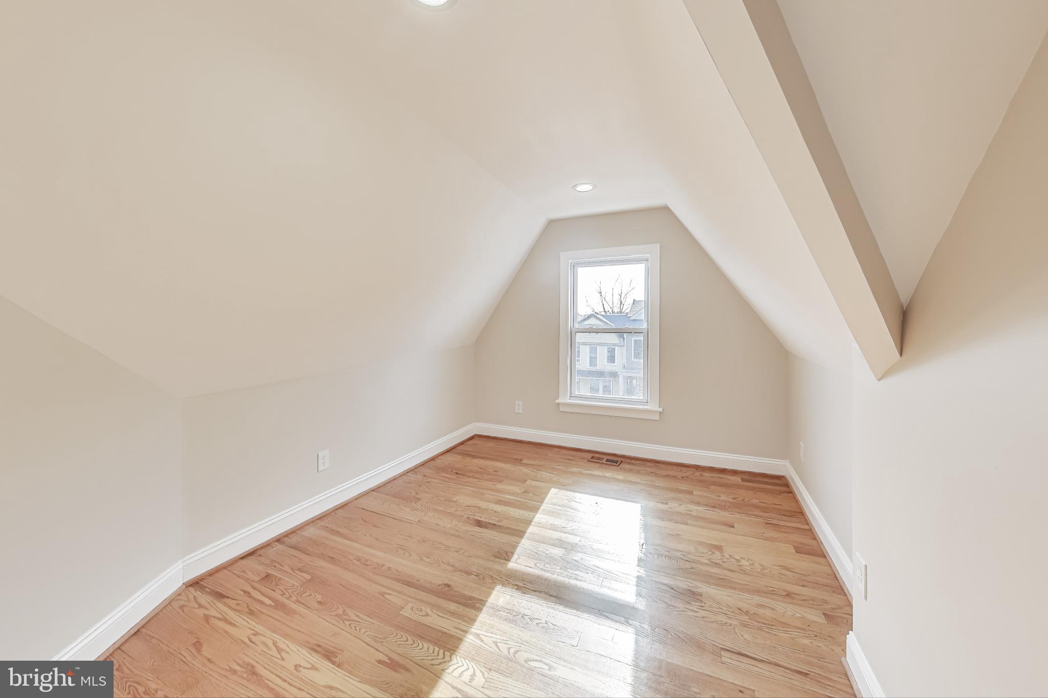 4301 Kansas Avenue Northwest Washington, DC 20011 - Photo 48 of 80 an empty room with wooden floor and windows