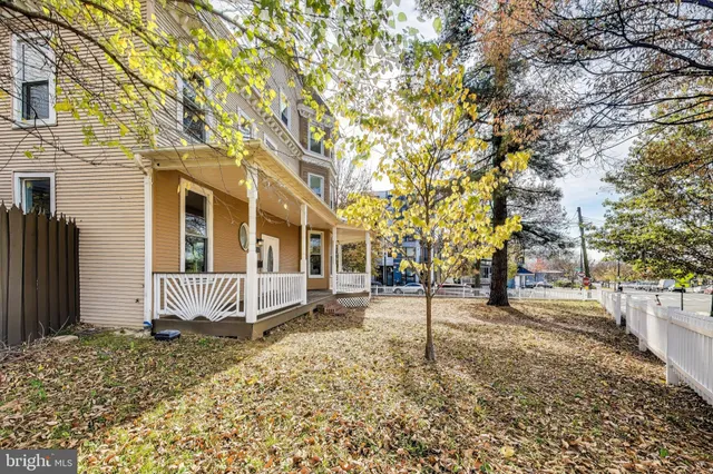 a living room with furniture and view of kitchen