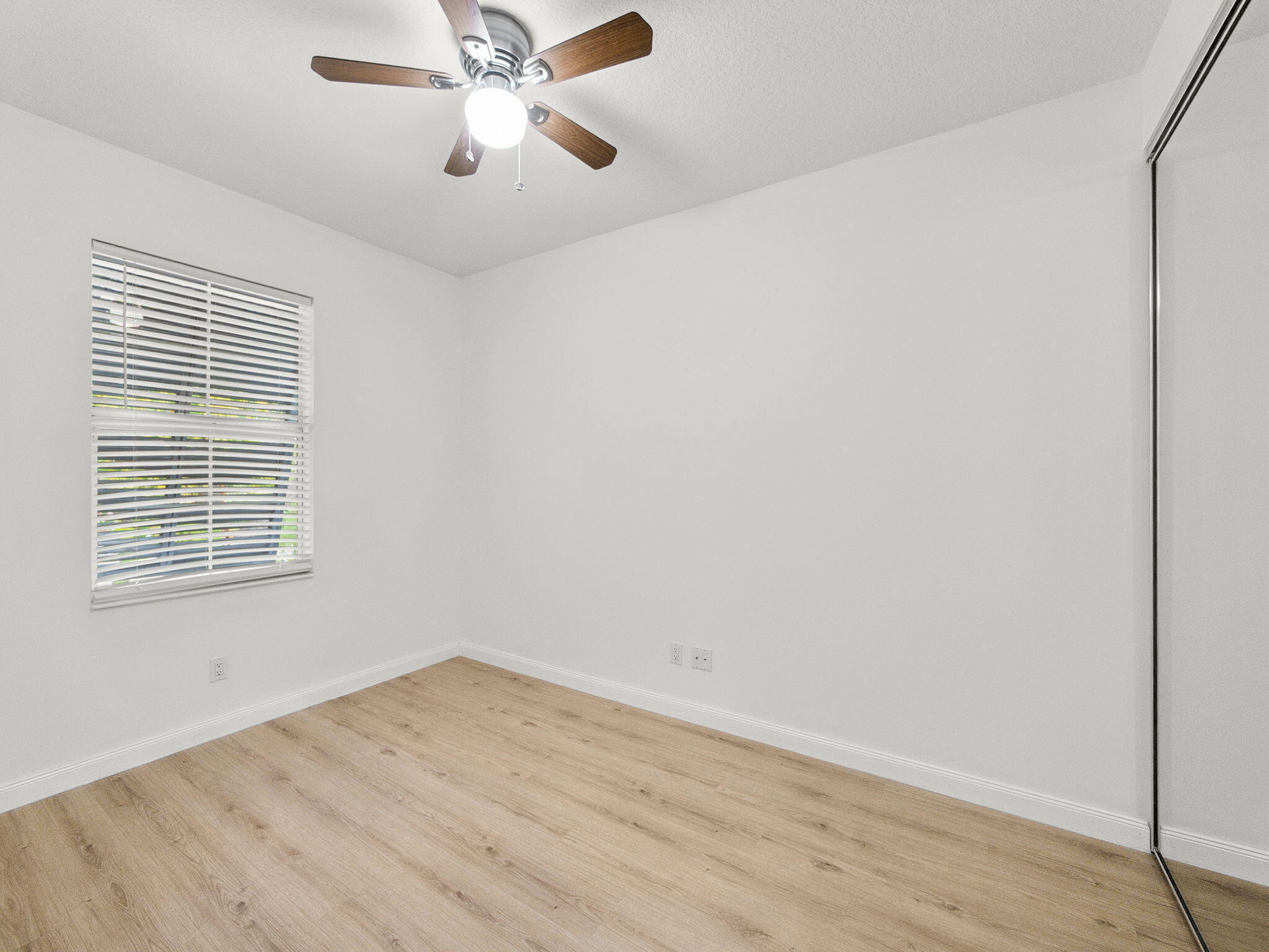 3119 East Community Drive Jupiter, FL 33458 - Photo 10 of 24 wooden floor in an empty room
