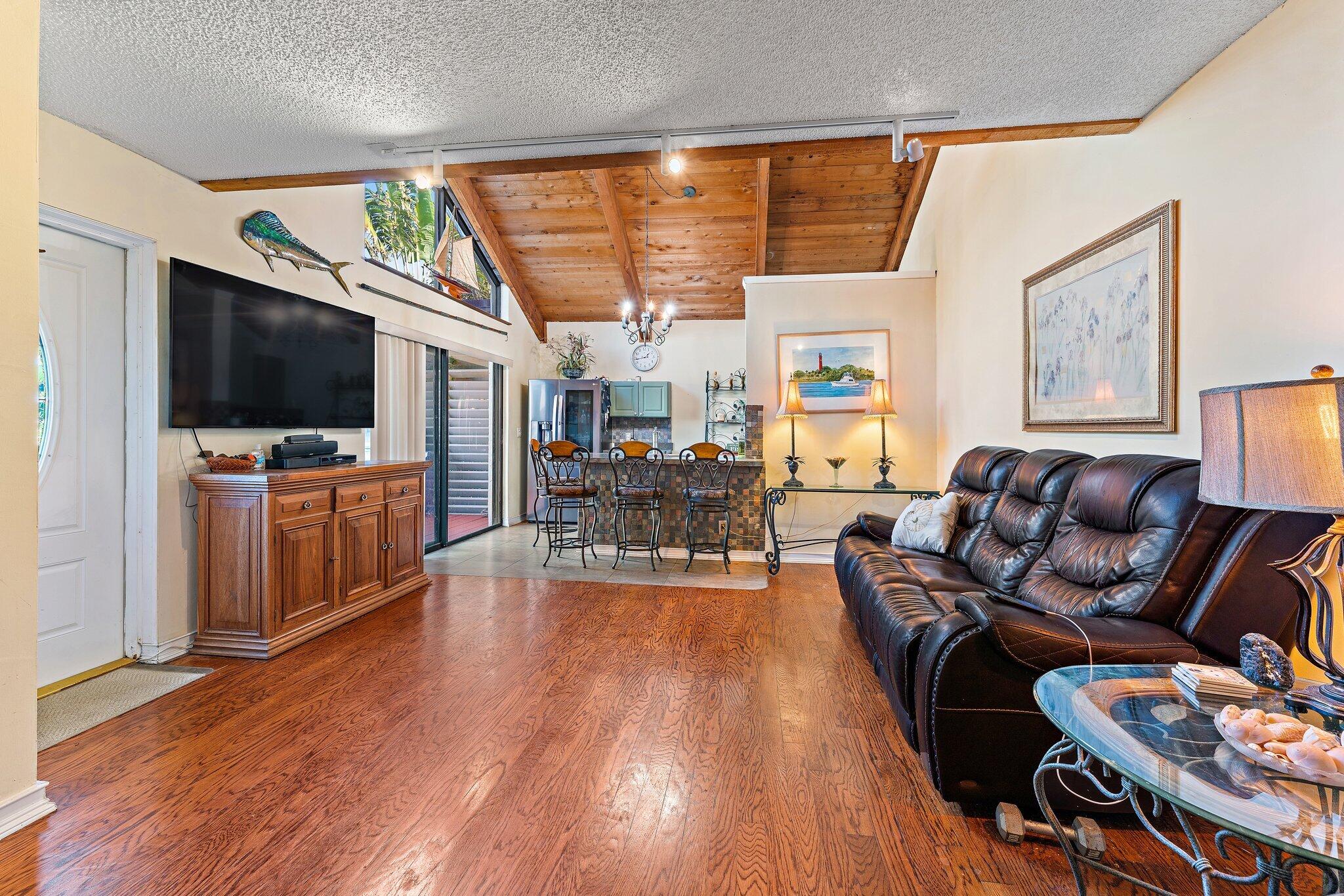 1605 Highway 1, Unit SL 5F Jupiter, FL 33477 - Photo 24 of 36 a living room with furniture and a flat screen tv