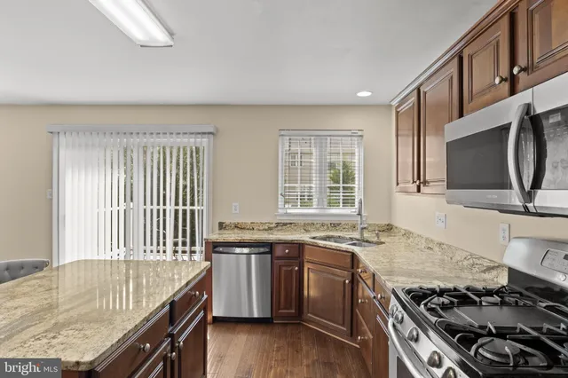 a living room with granite countertop furniture and wooden floor