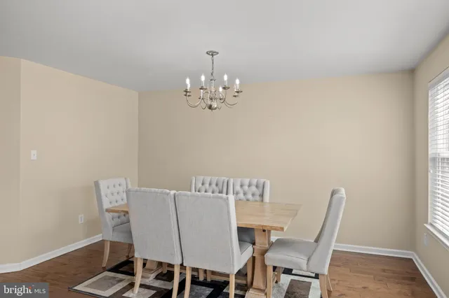 a bed sitting in a bedroom next to a window with a chandelier
