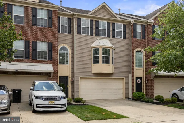 a car parked in front of a brick house