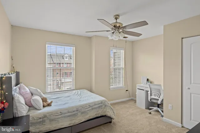 a view of a livingroom with entryway flat screen tv wooden shelves and closet