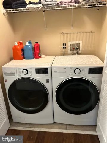a view of a house with brick walls and a yard with plants