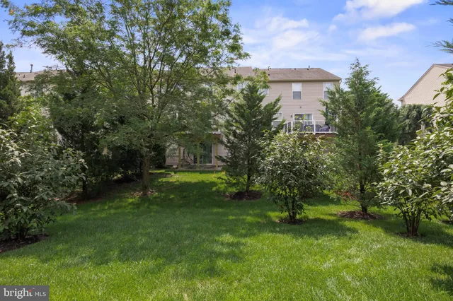 an aerial view of a house with a yard and garden