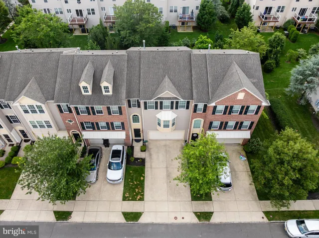 an aerial view of multiple houses with yard