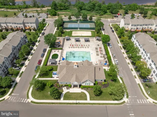 a view of a house with pool and chairs