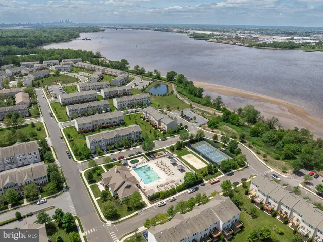 a view of a swimming pool with a patio and a yard