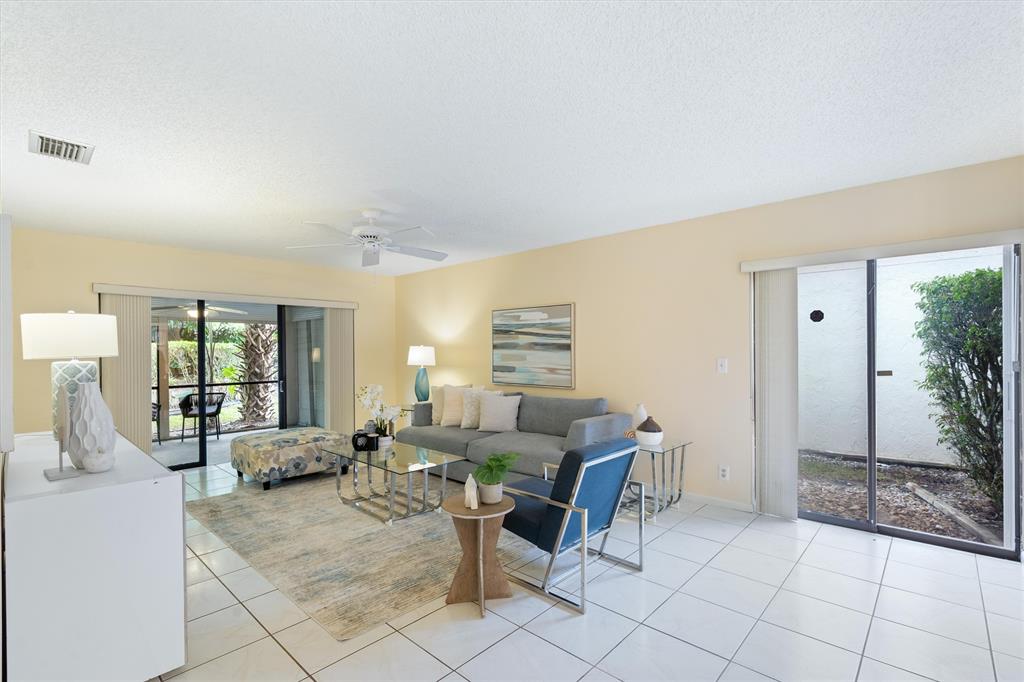 4342 Acacia Circle Coconut Creek, FL 33066 - Photo 11 of 20 a living room with furniture and a table