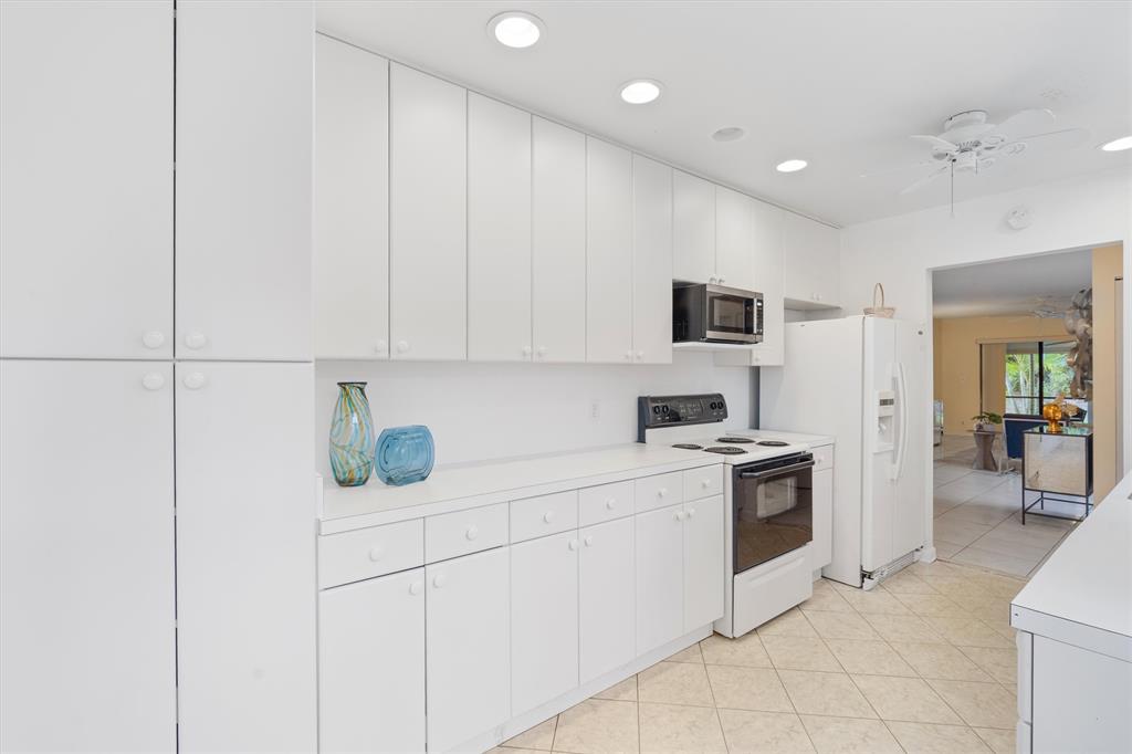 4342 Acacia Circle Coconut Creek, FL 33066 - Photo 14 of 20 a kitchen with a sink and white cabinets