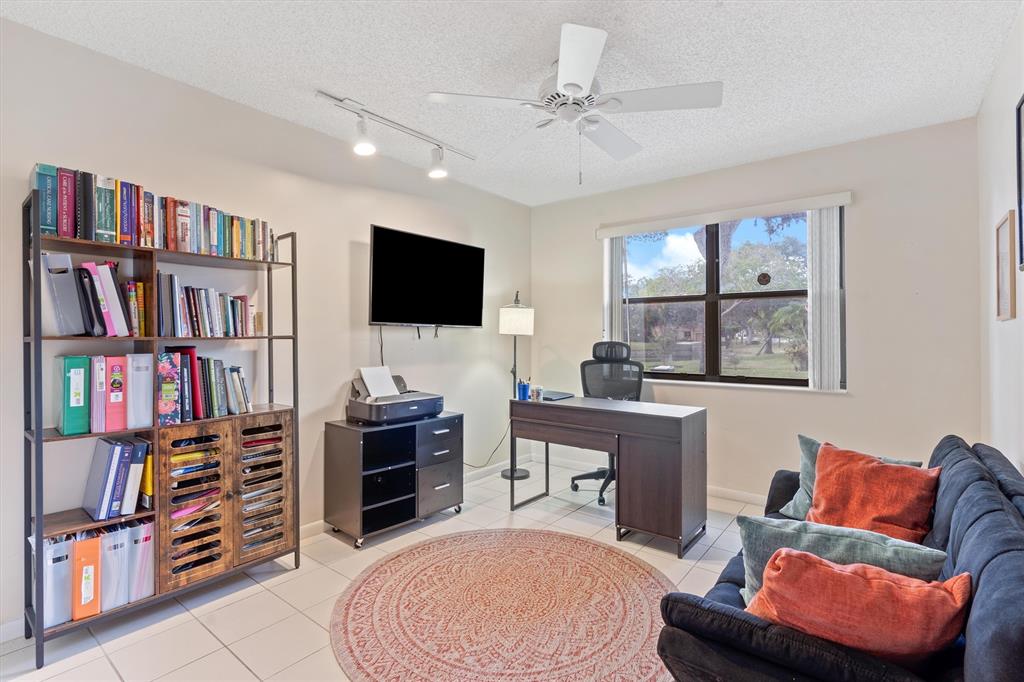 4342 Acacia Circle Coconut Creek, FL 33066 - Photo 16 of 20 a living room with furniture and a book shelf
