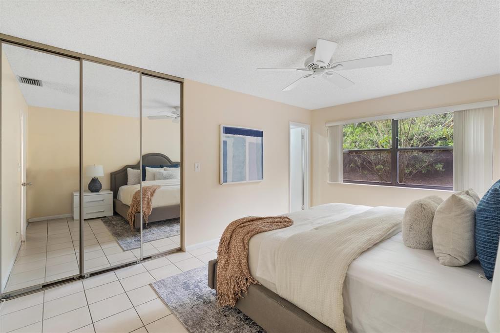 4342 Acacia Circle Coconut Creek, FL 33066 - Photo 18 of 20 a bedroom with a bed and window