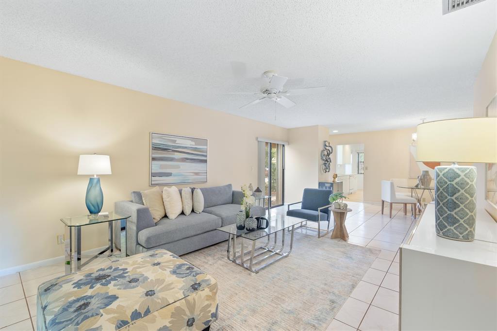 4342 Acacia Circle Coconut Creek, FL 33066 - Photo 2 of 20 a living room with furniture and a lamp
