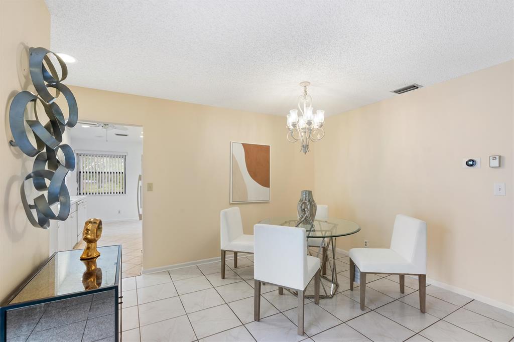 4342 Acacia Circle Coconut Creek, FL 33066 - Photo 3 of 20 a dining room with furniture and chandelier