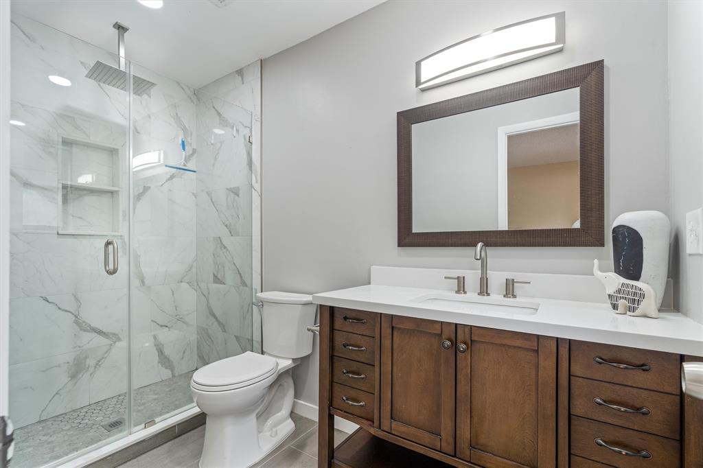 4342 Acacia Circle Coconut Creek, FL 33066 - Photo 5 of 20 a bathroom with a toilet sink double vanity and shower