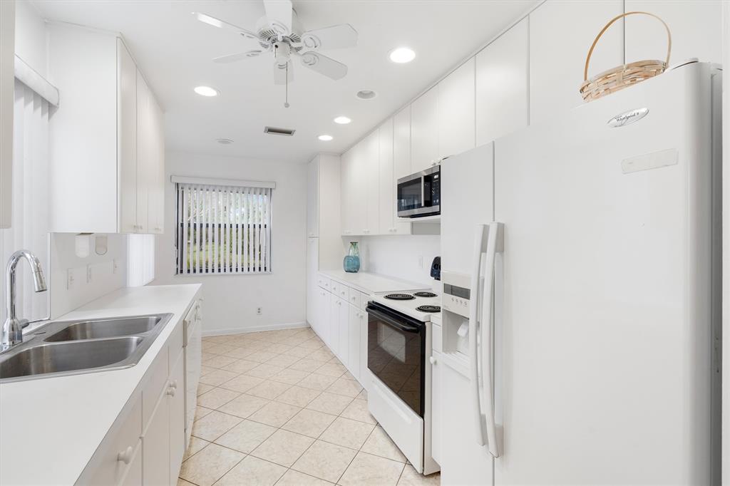 4342 Acacia Circle Coconut Creek, FL 33066 - Photo 6 of 20 a kitchen with stainless steel appliances granite countertop a sink stove and refrigerator