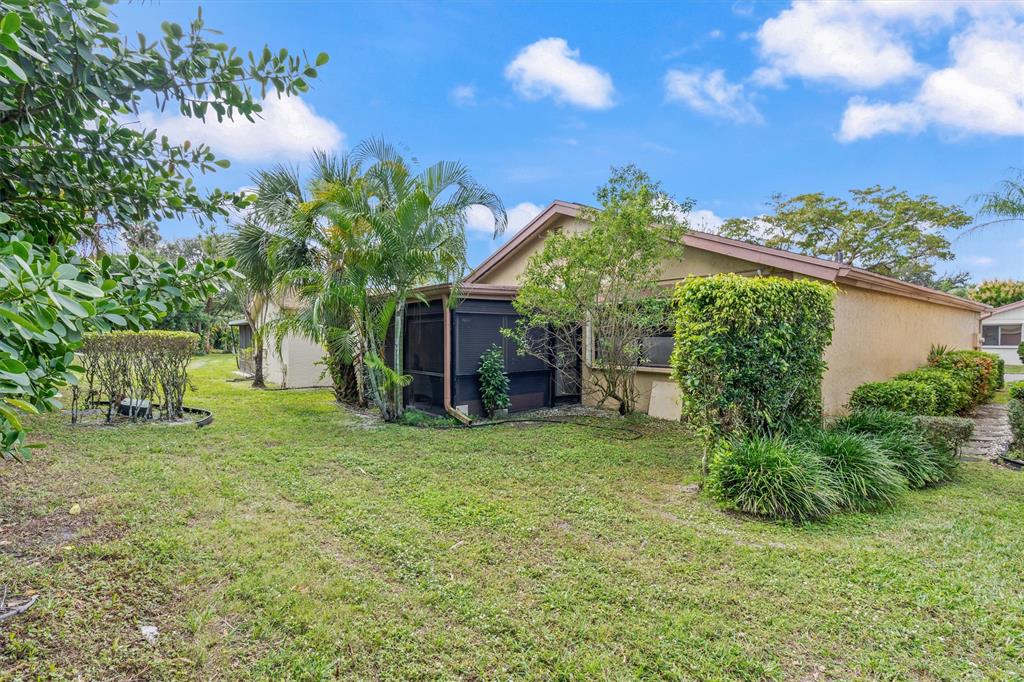 4342 Acacia Circle Coconut Creek, FL 33066 - Photo 10 of 20 a backyard of a house with plants and large tree