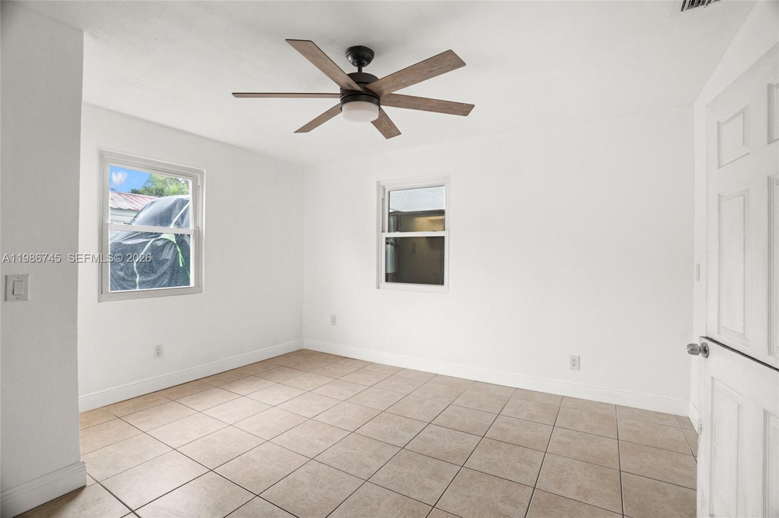 2810 Northeast 11th Terrace Pompano Beach, FL 33064 - Photo 11 of 33 a view of a big room with wooden floor and windows