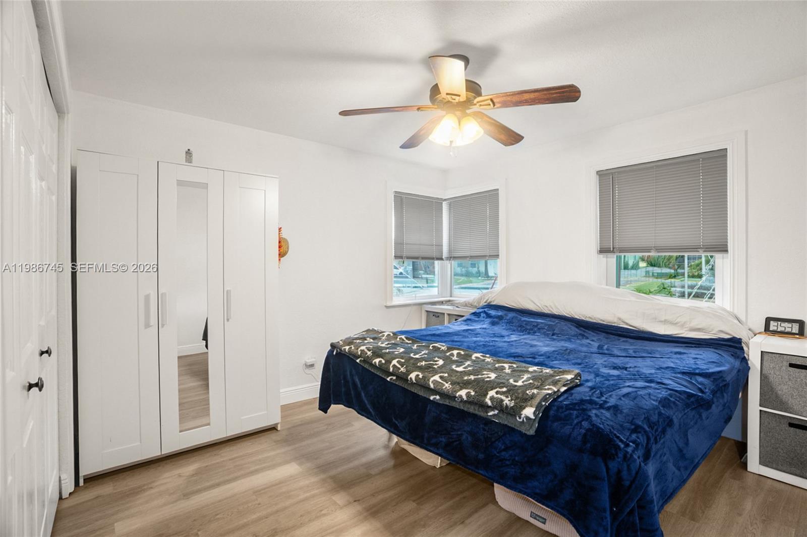 2810 Northeast 11th Terrace Pompano Beach, FL 33064 - Photo 18 of 33 a bedroom with a bed and a chandelier