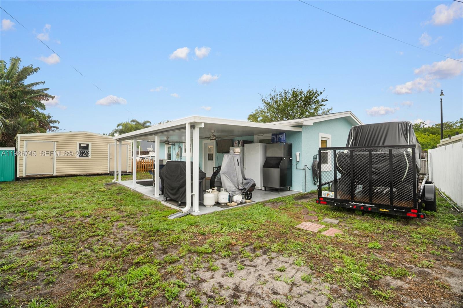 2810 Northeast 11th Terrace Pompano Beach, FL 33064 - Photo 20 of 33 a view of a house with backyard and porch
