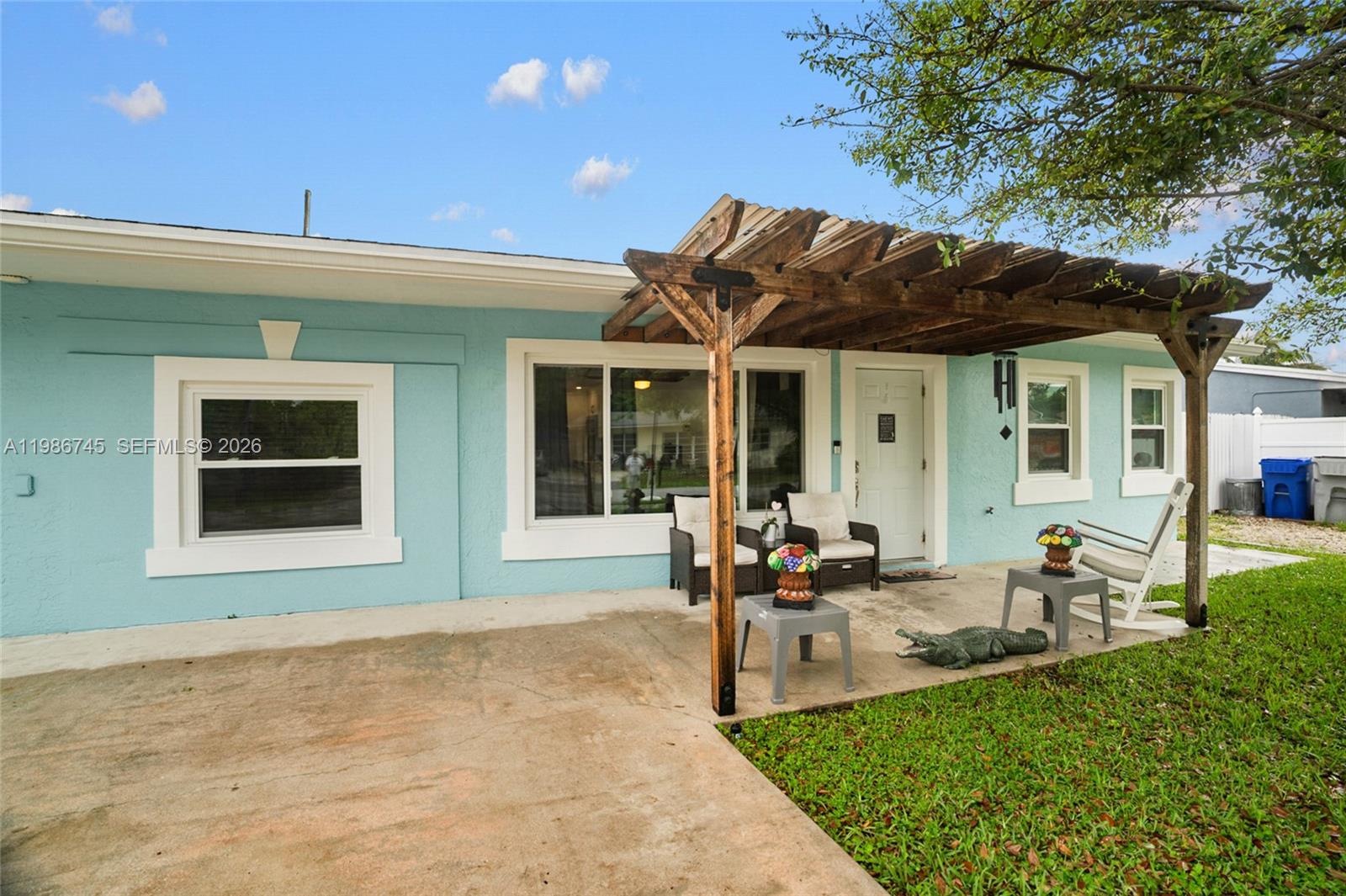 2810 Northeast 11th Terrace Pompano Beach, FL 33064 - Photo 2 of 33 a front view of a house with garden and porch