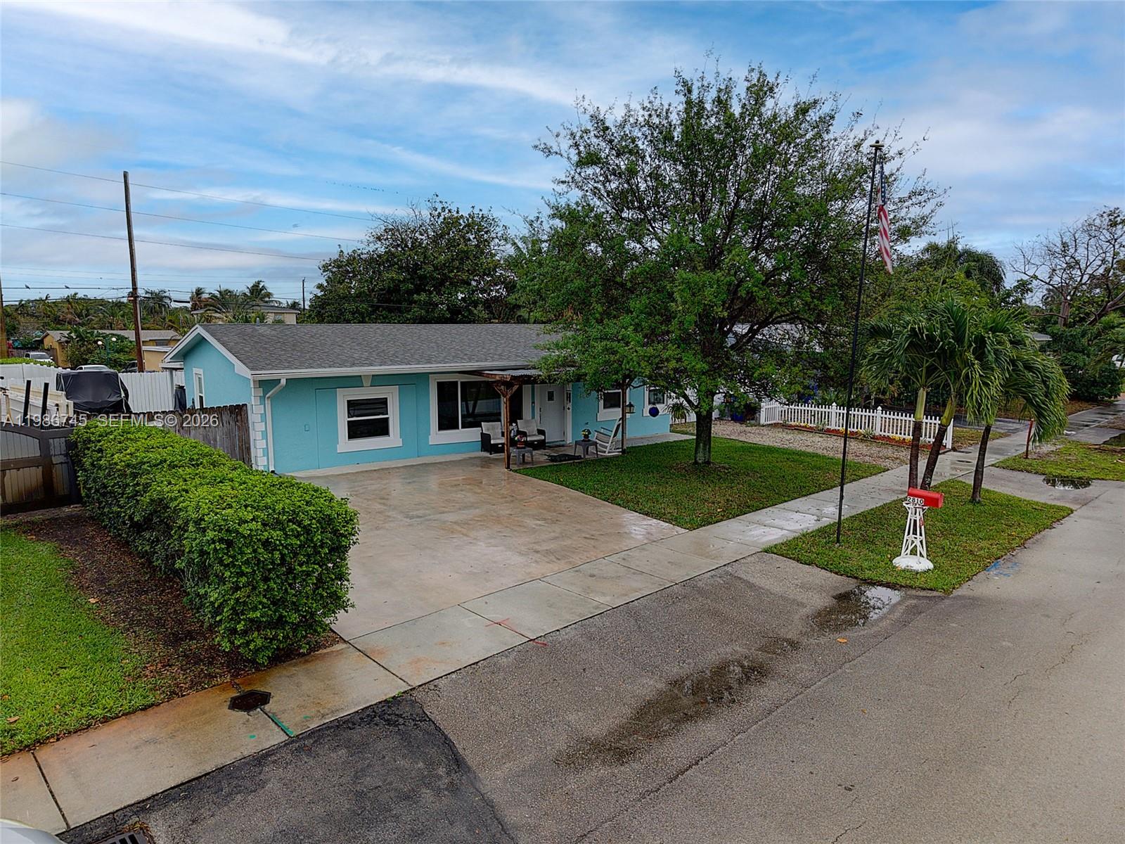 2810 Northeast 11th Terrace Pompano Beach, FL 33064 - Photo 23 of 33 a front view of a house with a yard