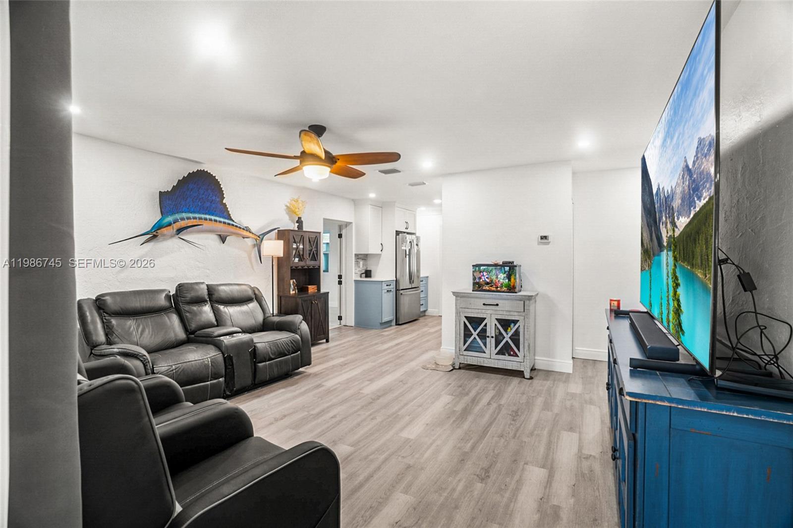 2810 Northeast 11th Terrace Pompano Beach, FL 33064 - Photo 3 of 33 a living room with furniture and a flat screen tv