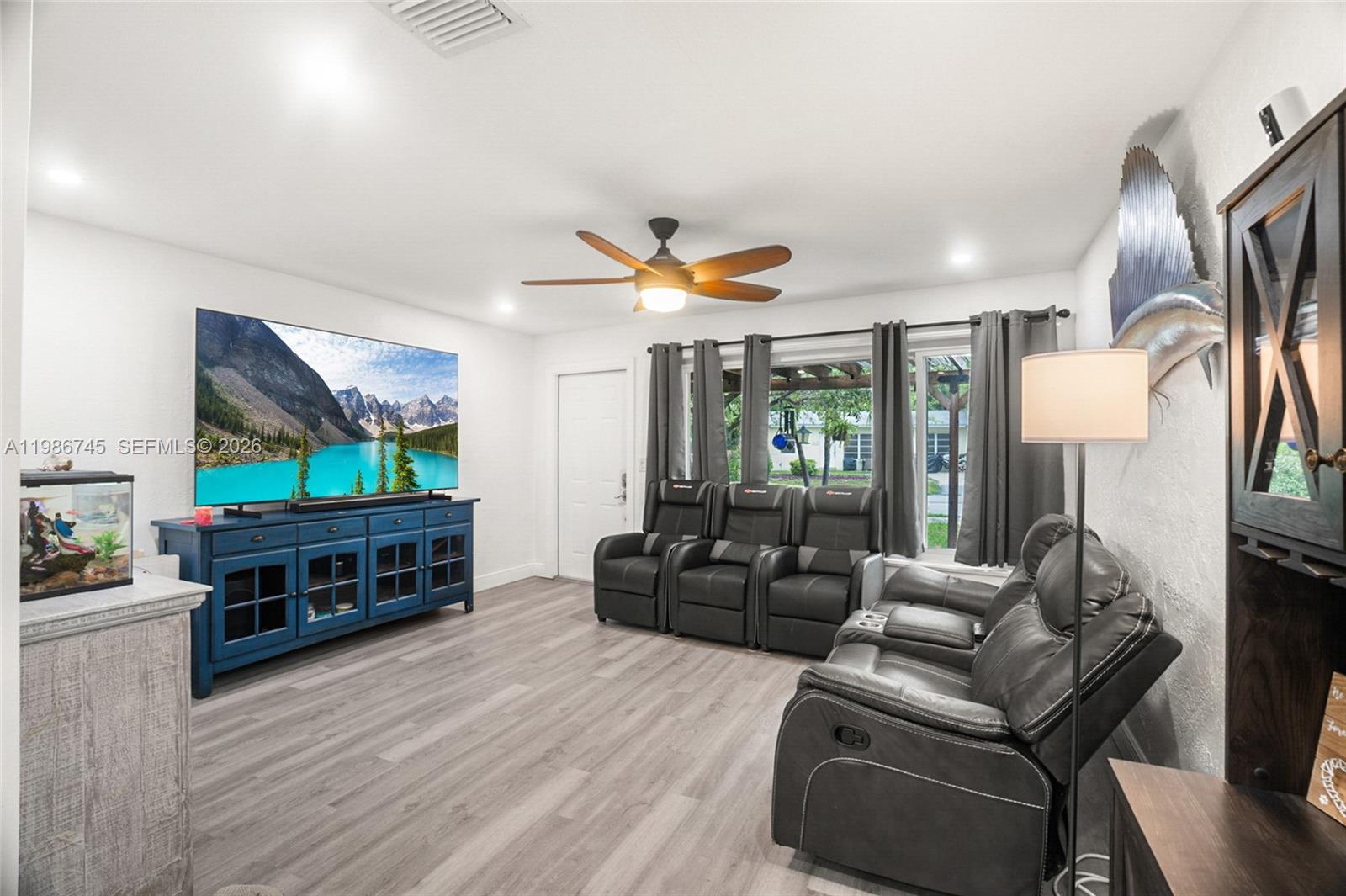 2810 Northeast 11th Terrace Pompano Beach, FL 33064 - Photo 4 of 33 a living room with furniture and a flat screen tv