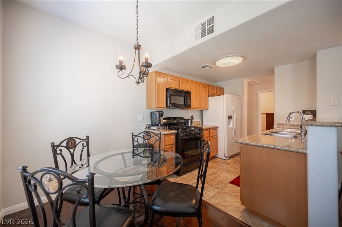 7701 West Robindale Road, Unit 274 Las Vegas, NV 89113 - Photo 10 of 38 This cozy kitchen features a practical layout with warm wooden cabinetry and durable flooring.
